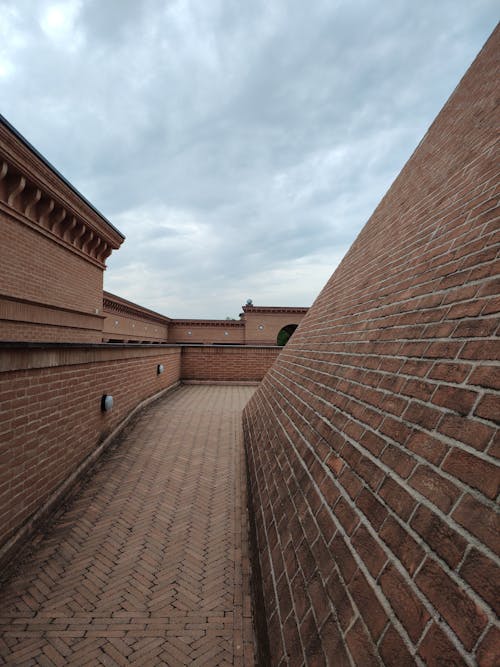 Clouds over Building Walls Bricks and Pavement