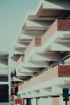 Photo of a contemporary building with a geometric facade and brick exterior.