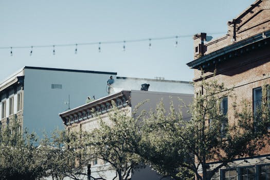 A cityscape with workers on a rooftop amidst historic buildings.