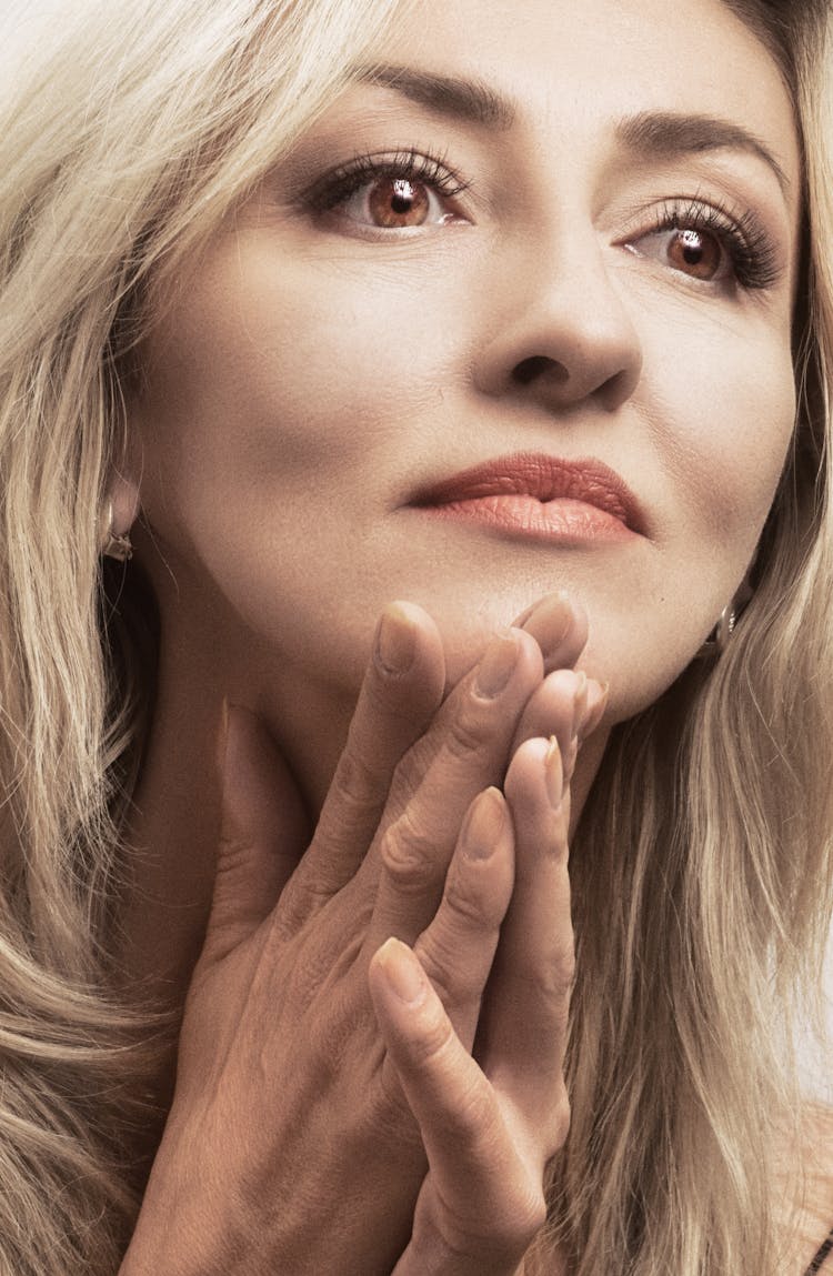 Face And Hands Of Blonde Woman