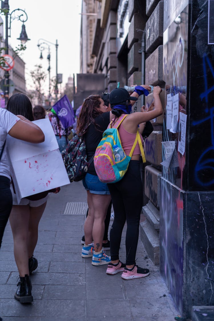 Women Drawing On A Wall 