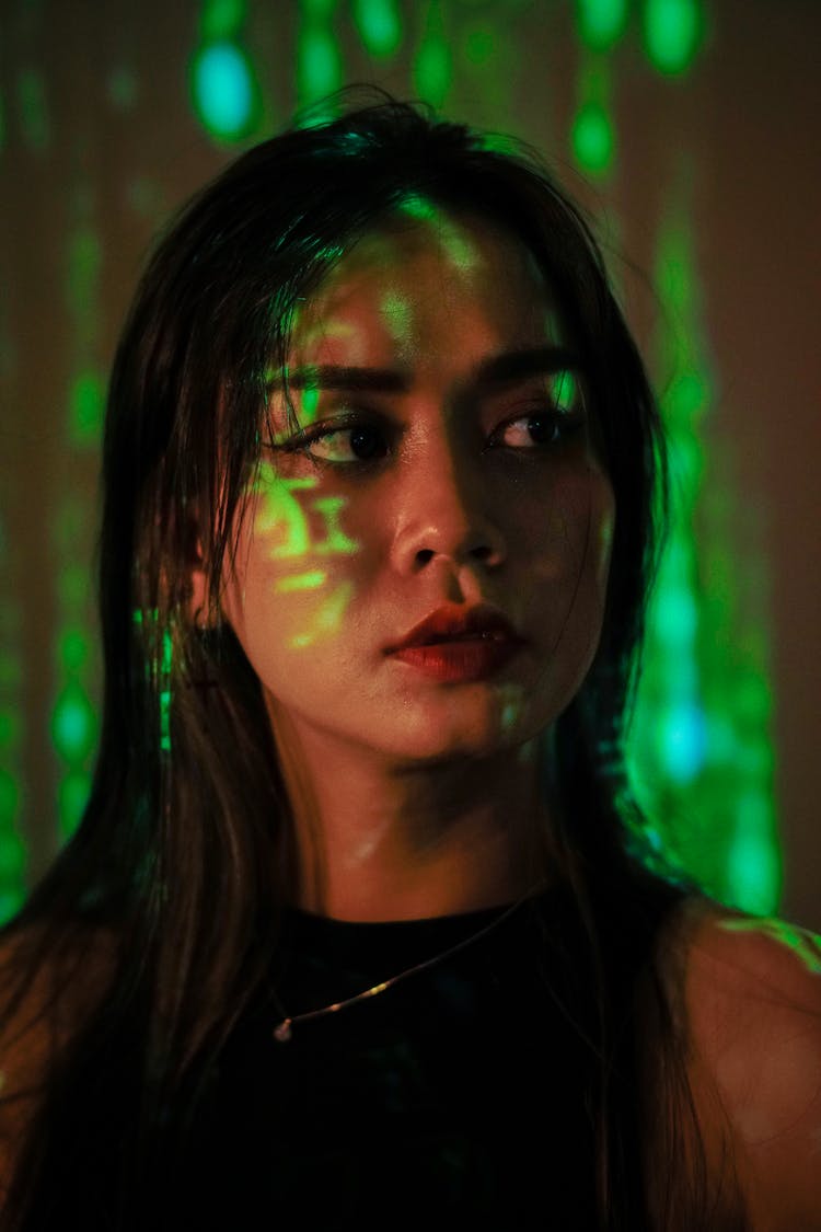 A Woman With Green And Green Lights On Her Face