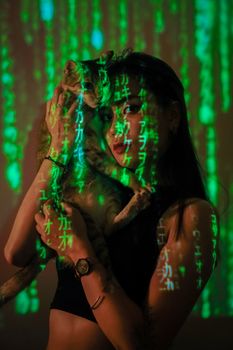 A woman with a cat, surrounded by a matrix-style code in green light.
