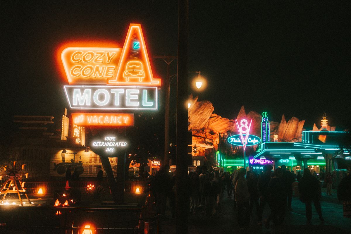 Historic highway motel sign glowing with retro neon warmth at night