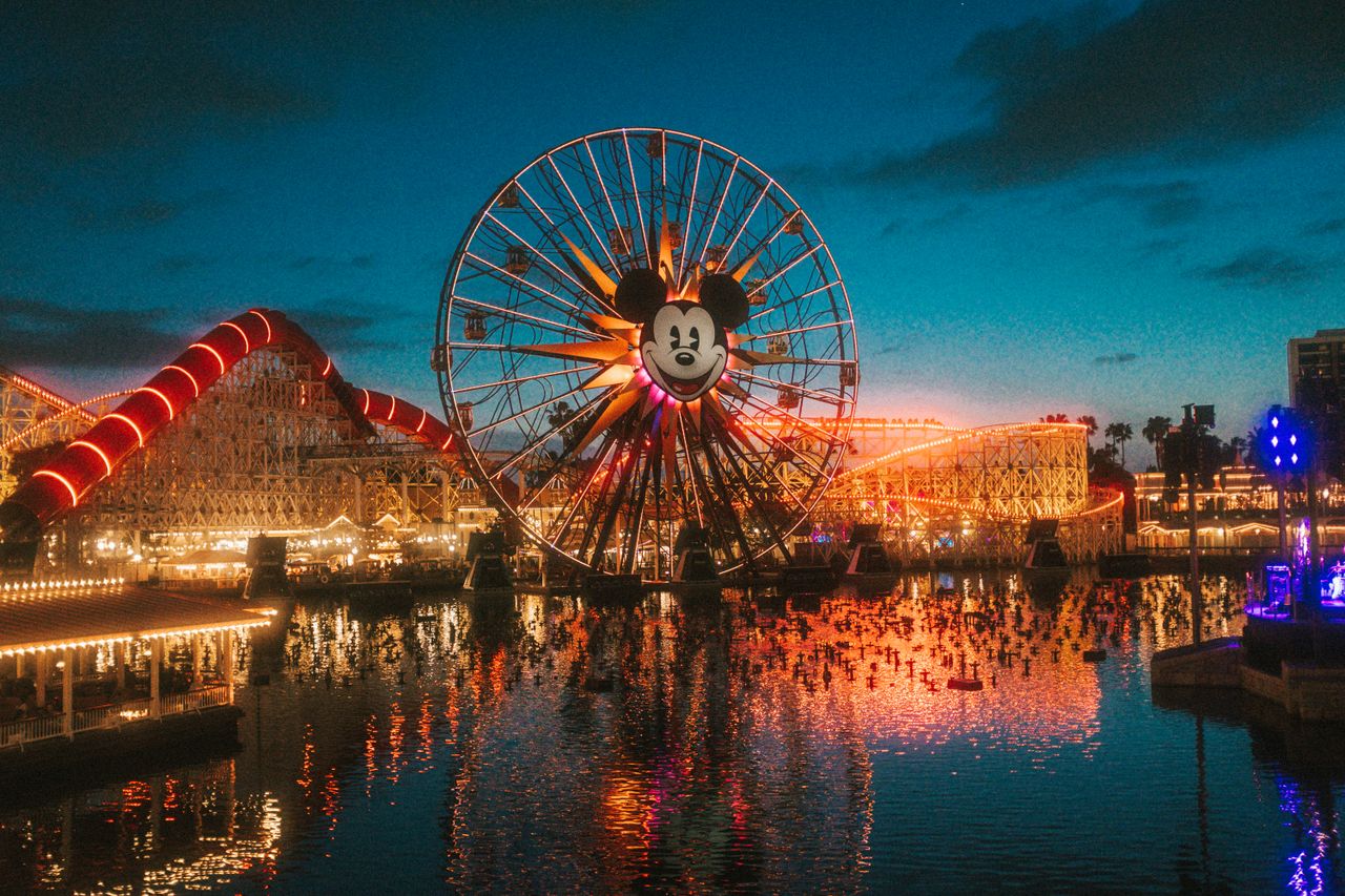 stunning view of a brightly lit ferris wheel at a theme park during su