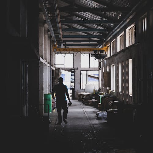 Silhouette of Man in Warehouse