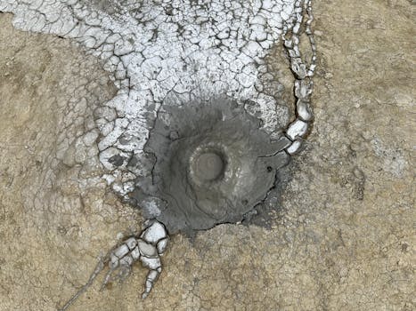 Top view of a cracked mud volcano with an arid, earthy texture.