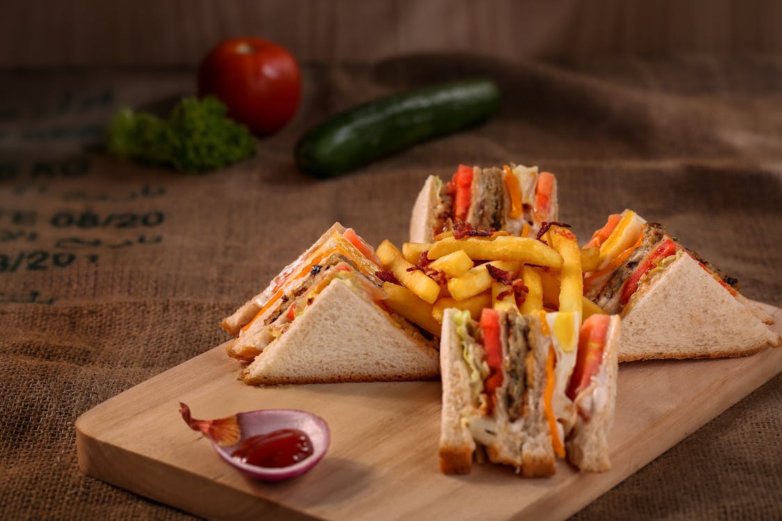 Free Club Sandwich Served on Chopping Board Stock Photo