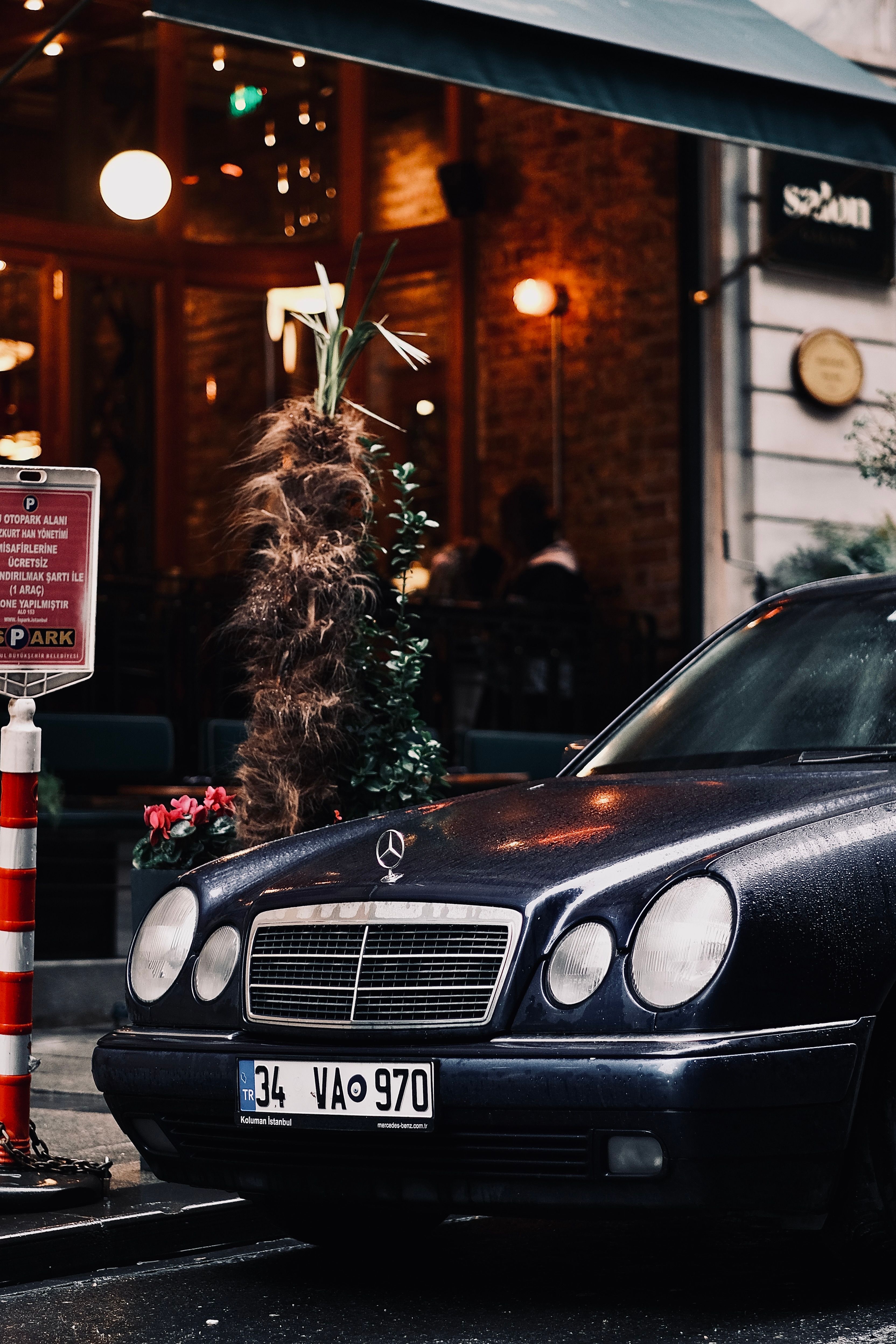 Elegant Mercedes-Benz parked on a rainy urban street at night.