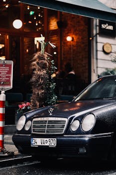 Elegant Mercedes-Benz parked on a rainy urban street at night.