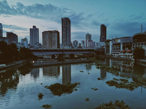 Free Photo of Body of Water Near Concrete Buildings  Stock Photo