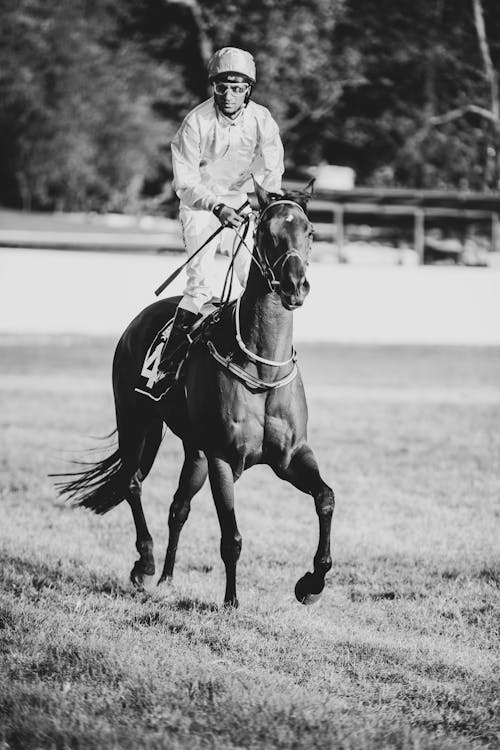 Black and White Photo of a Jockey Riding a Racehorse