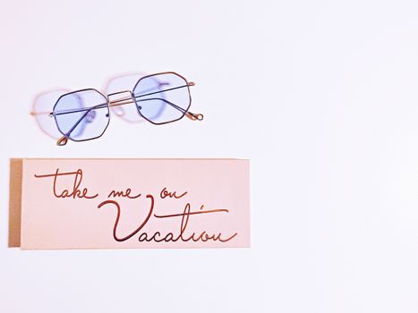 Minimalist image featuring eyeglasses and a 'Vacation' card, perfect for travel themes.