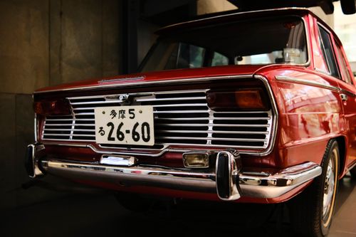 Free A classic vintage red car with a retro design, photographed in London showcasing its unique tail lights and license plate. Stock Photo