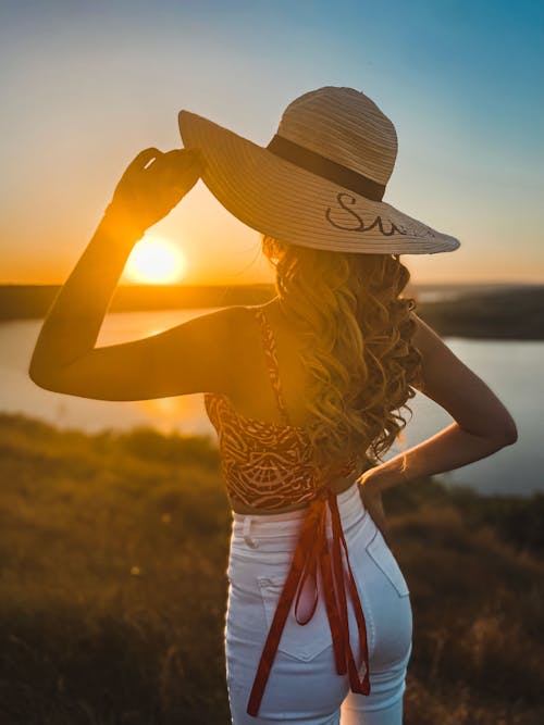 Woman in Hat Posing at Sunset