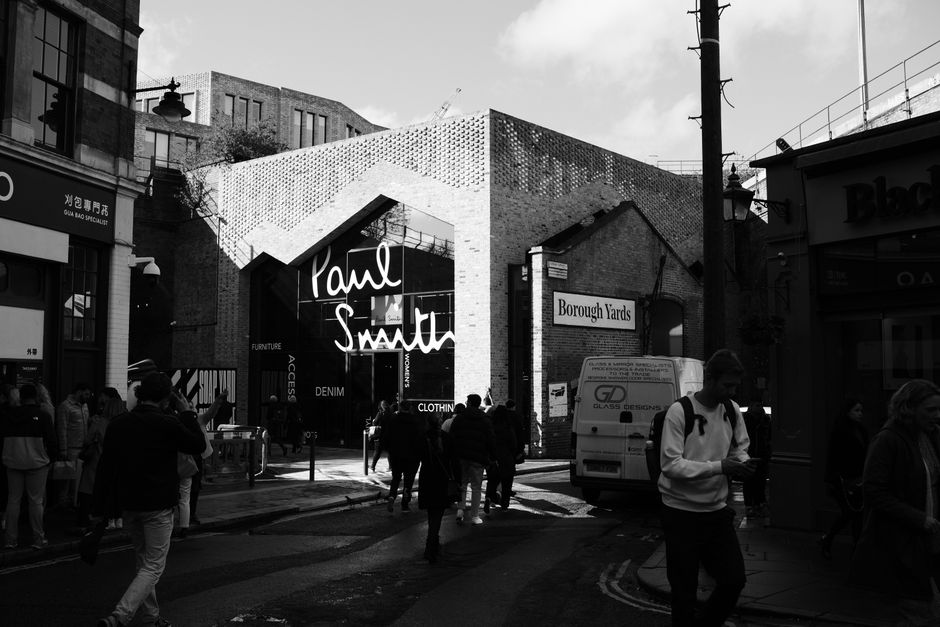 Black and white street photo of Borough Yards in London with people walking.