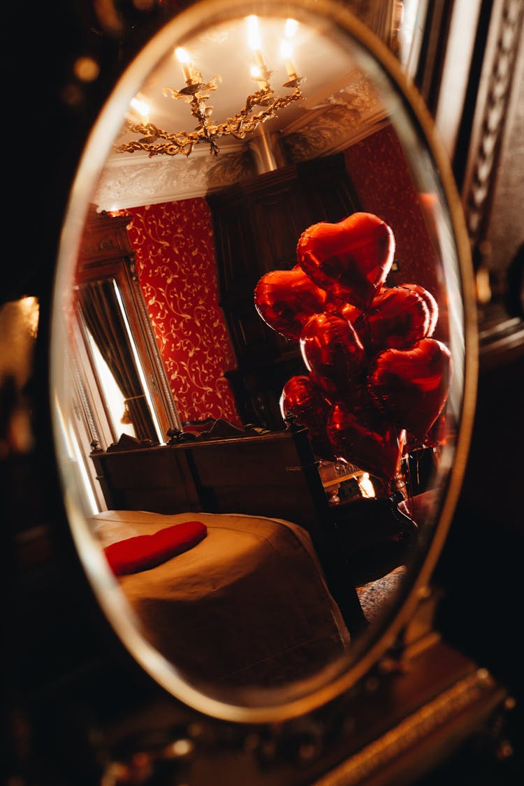 Mirror Reflection Of Hotel Room With Heart Shape Balloons