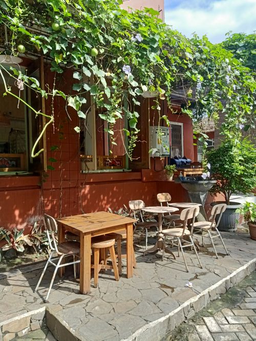 Free Cozy outdoor terrace with wooden furniture and climbing plants in a rustic Java setting. Stock Photo