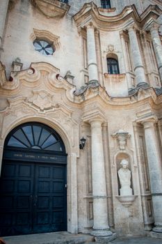 Elegant classical facade with arched doorway and columns in Havana, Cuba.