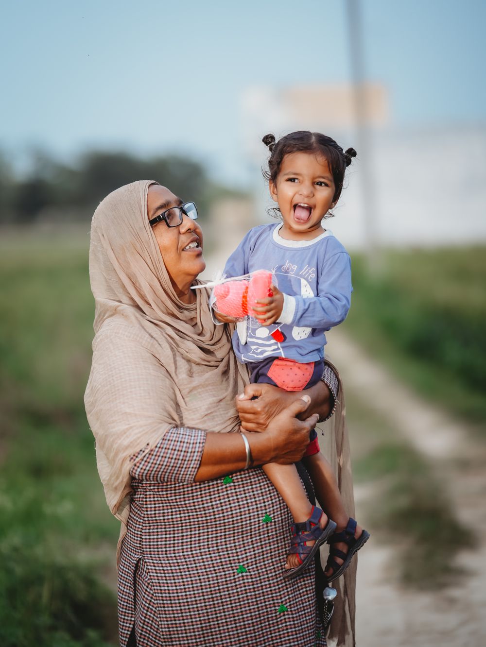 A grandmother holding a little girl