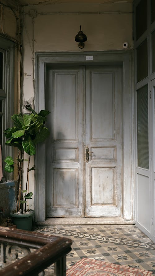 Old Wooden Door and Vintage Floor Tiles in a Building 