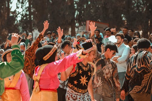 A Group of People in Traditional Clothing Dancing in the Crowd 