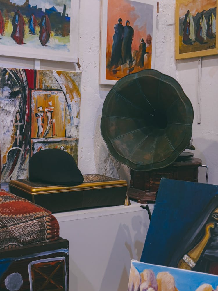 An Antique Gramophone And Paintings On The Wall 