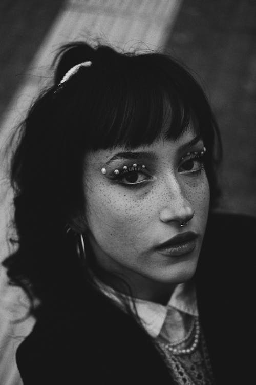 High Angle Shot of a Young Woman with Bangs and Nose Piercing 