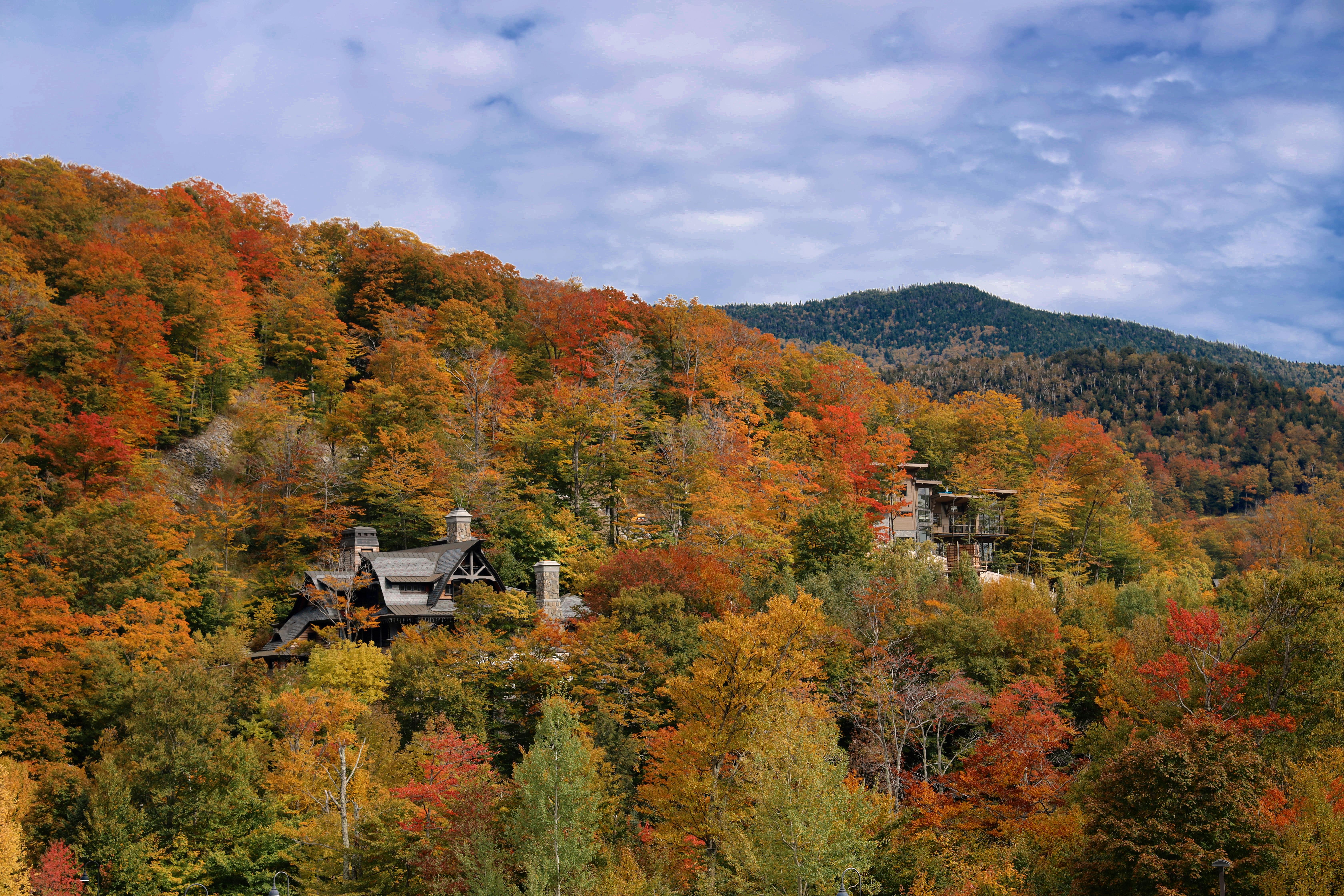 Aerial view of vibrant autumn foliage surrounding buildings in Stowe, Vermont.