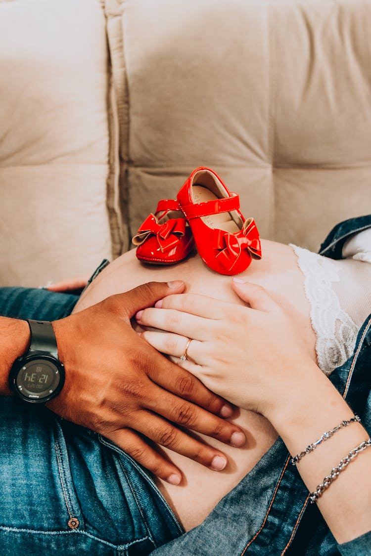 Woman And Man Hands On Pregnant Stomach