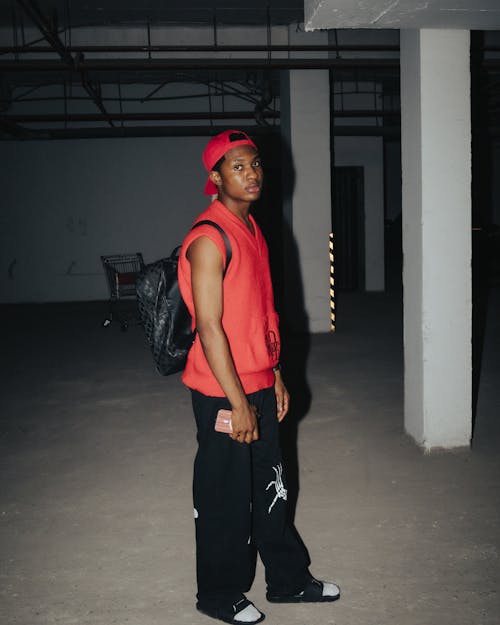 Man Posing in Cap and Tank Top