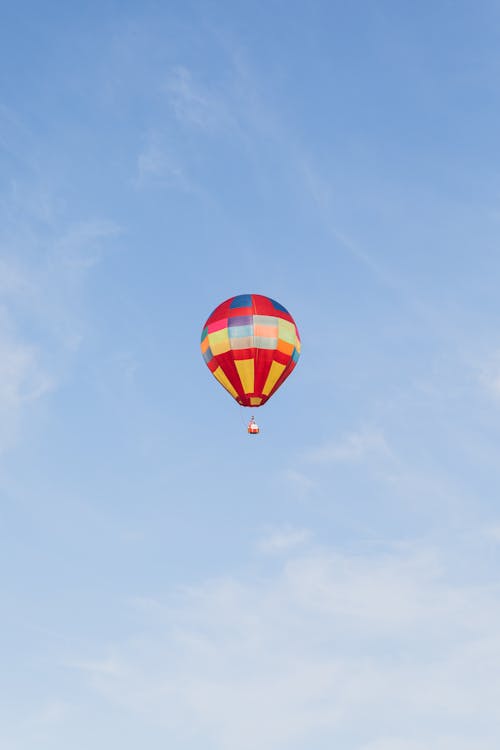 View of a Hot Air Balloon Flying against Blue Sky 