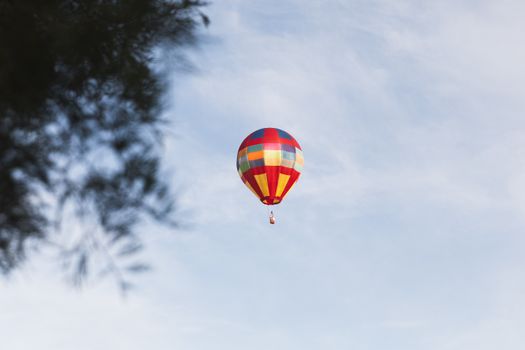 Vibrant hot air balloon floating in the skies of Hamilton, New Zealand, offering a thrilling adventure experience.