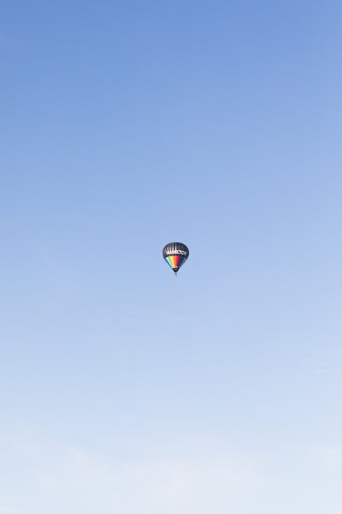 View of a Hot Air Balloon Flying against Blue Sky 