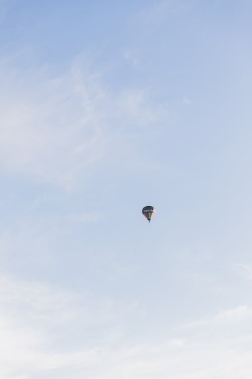 View of a Hot Air Balloon Flying against Blue Sky 