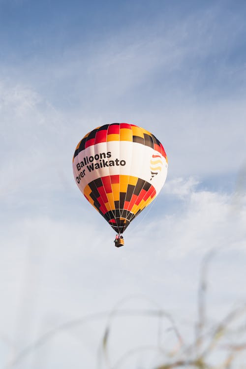 Hot Air Balloon with the Name of the Event on the Blue Sky