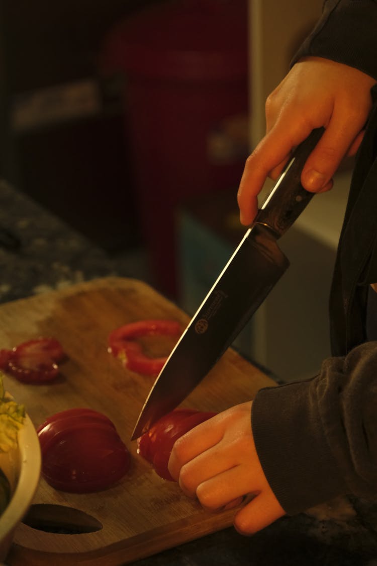 Hands Cutting Tomatoes