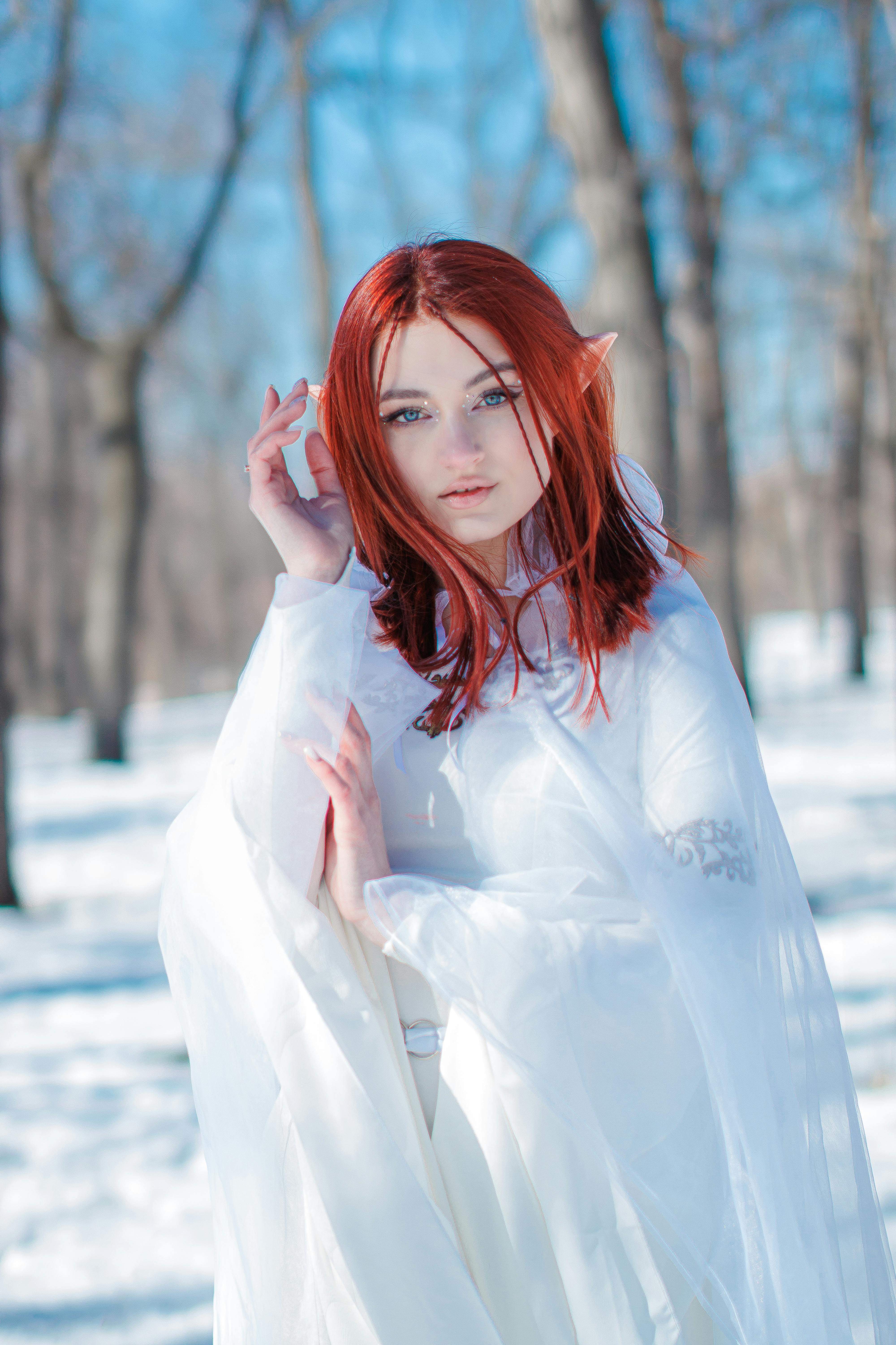 Redhead Girl in an Elf Costume Posing Outdoors in Snow · Free Stock Photo