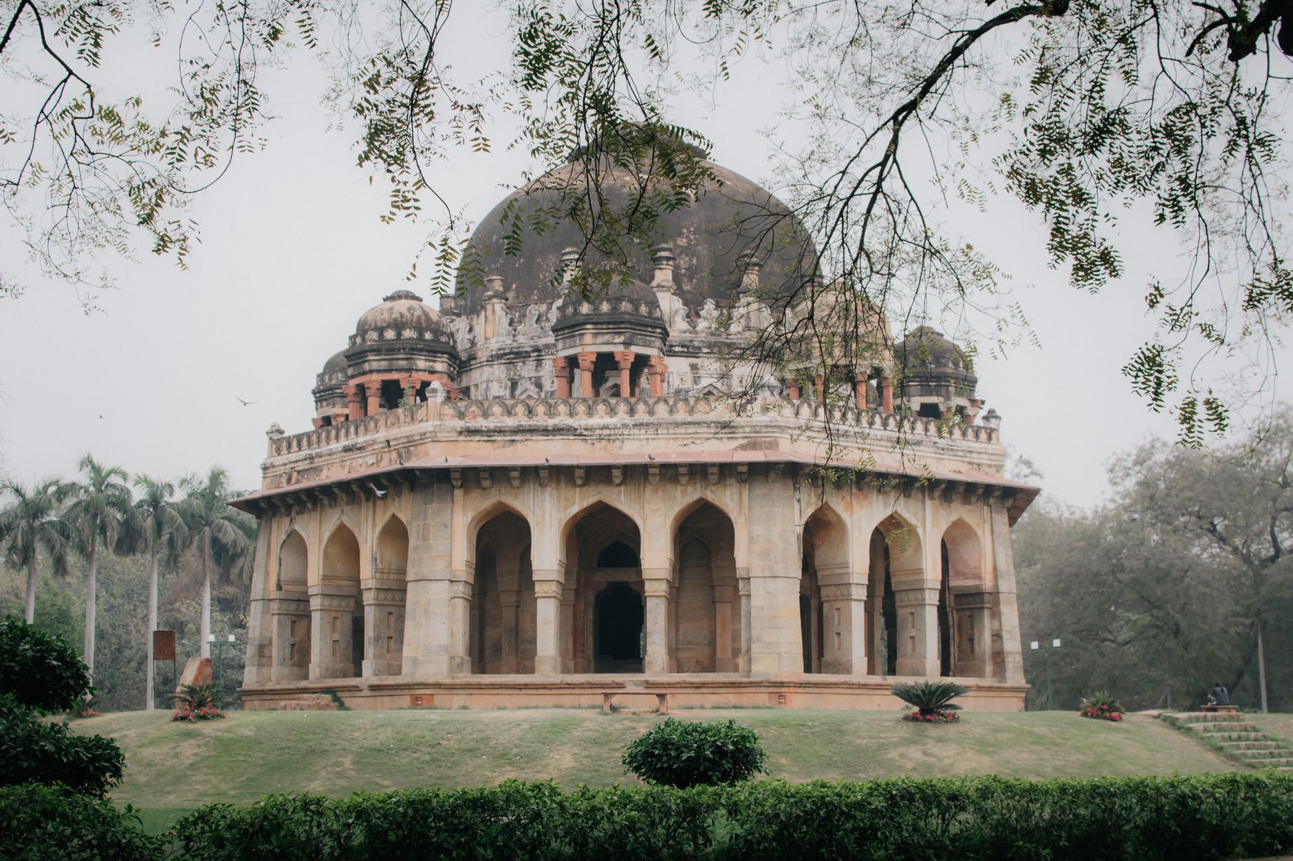 Featured image for the article: At Lodhi Garden, August light shifts from blue sky to lamp-lit paths