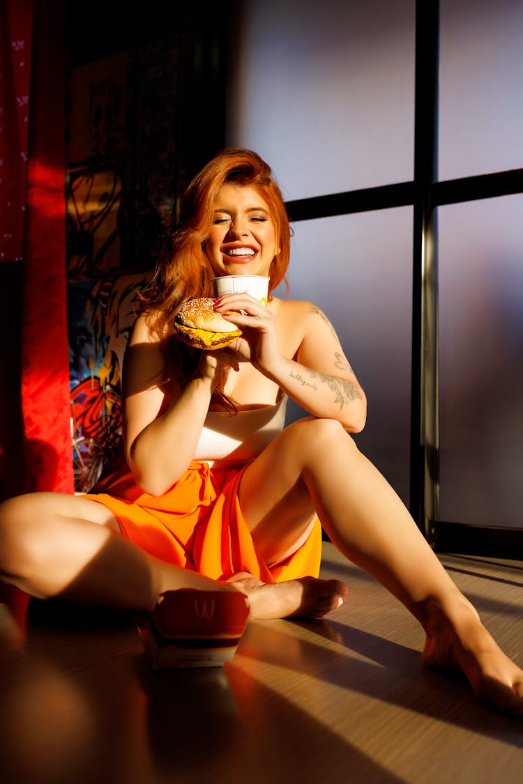 Woman Eating Fast Food, Sitting On Floor