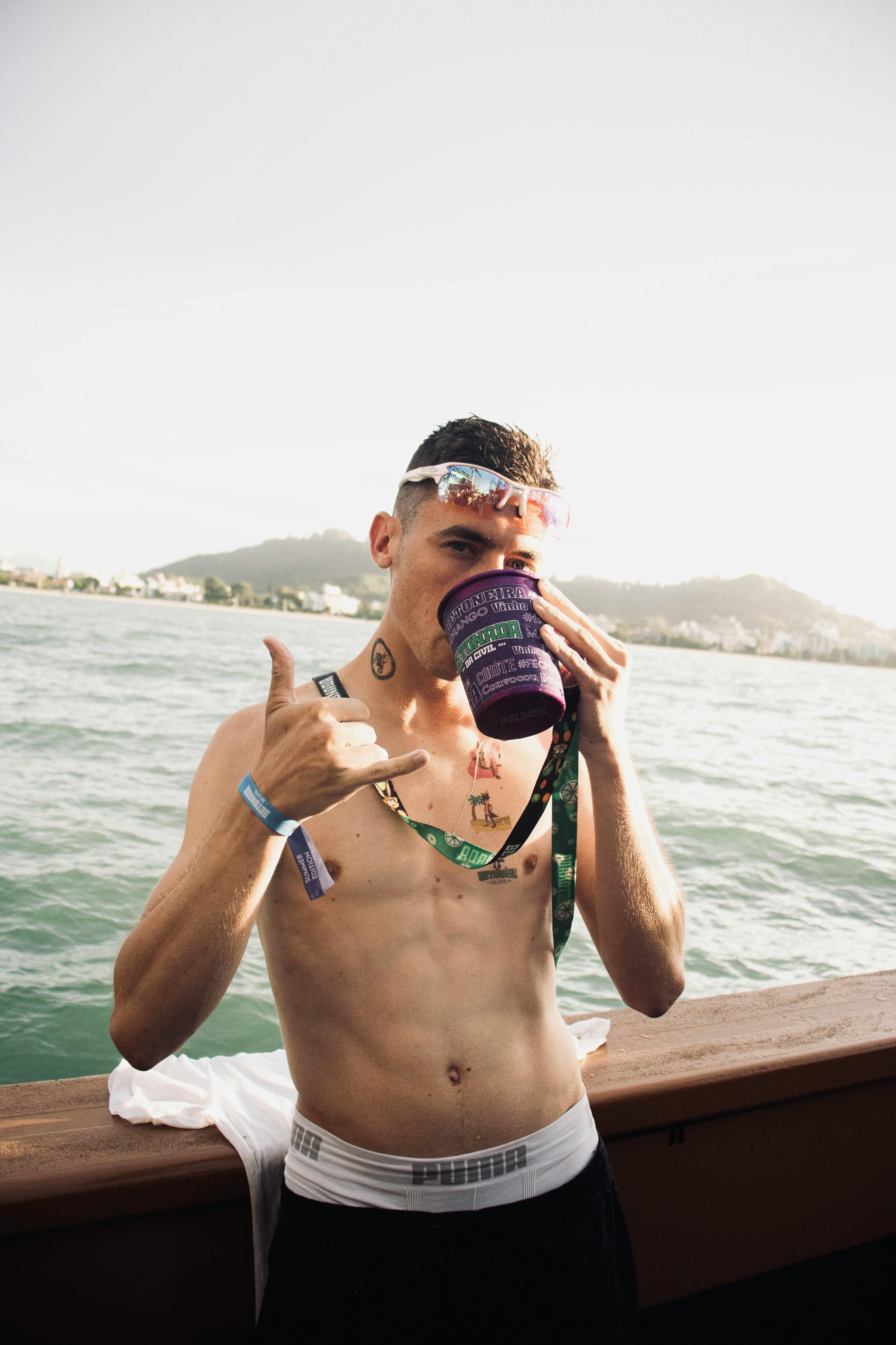 Topless Man Drinking · Free Stock Photo