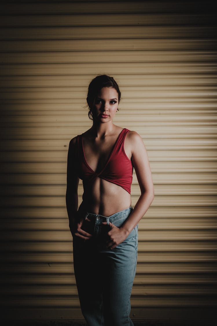 Young Woman Posing On Garage Gates Background