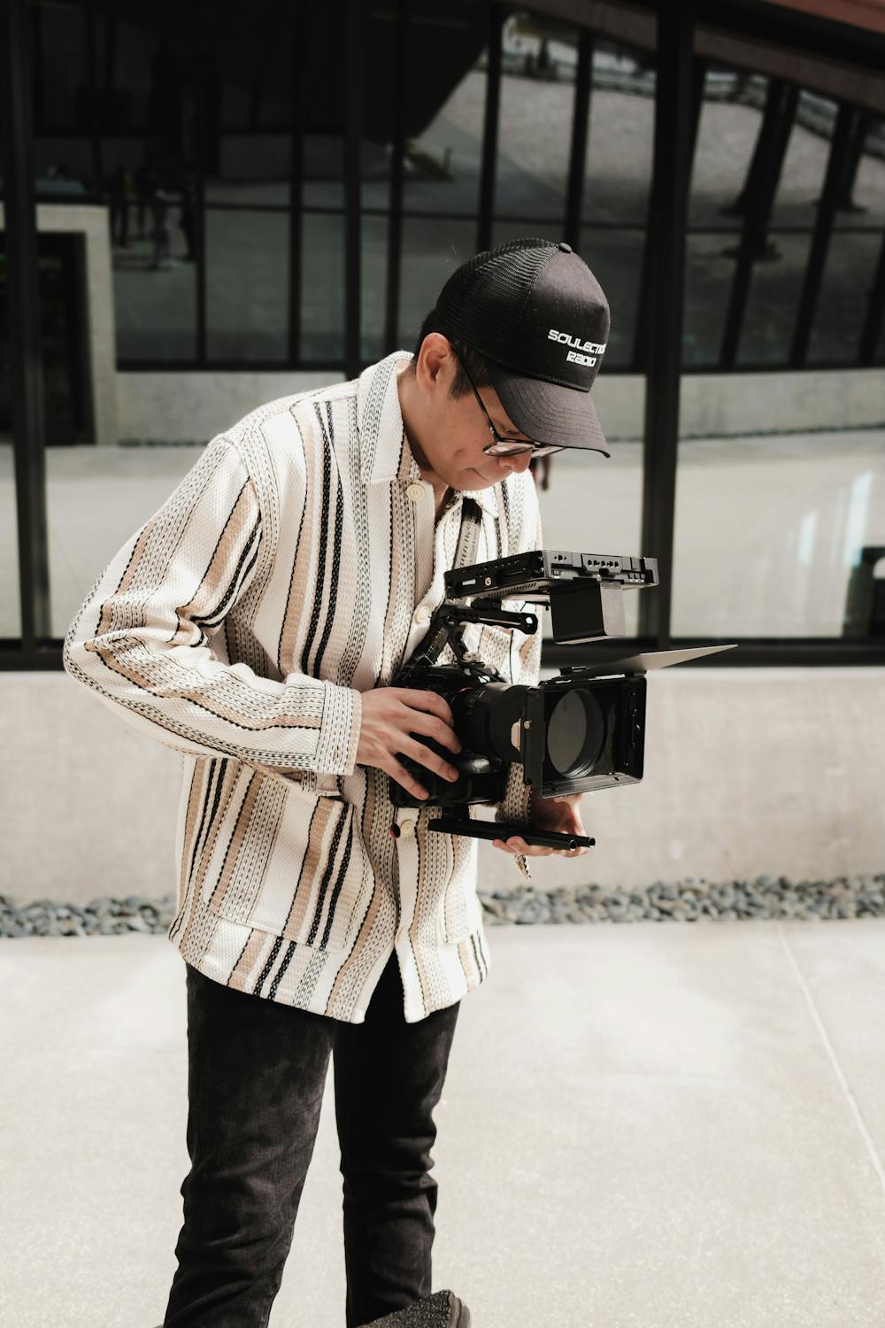 Man with Professional Camera Filming Outdoors · Free Stock Photo