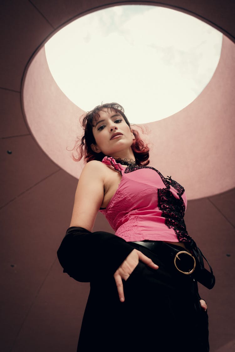 Young Woman Posing Under Building Ceiling