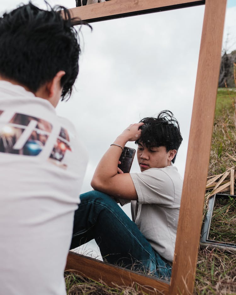 Man Taking Pictures In Mirror