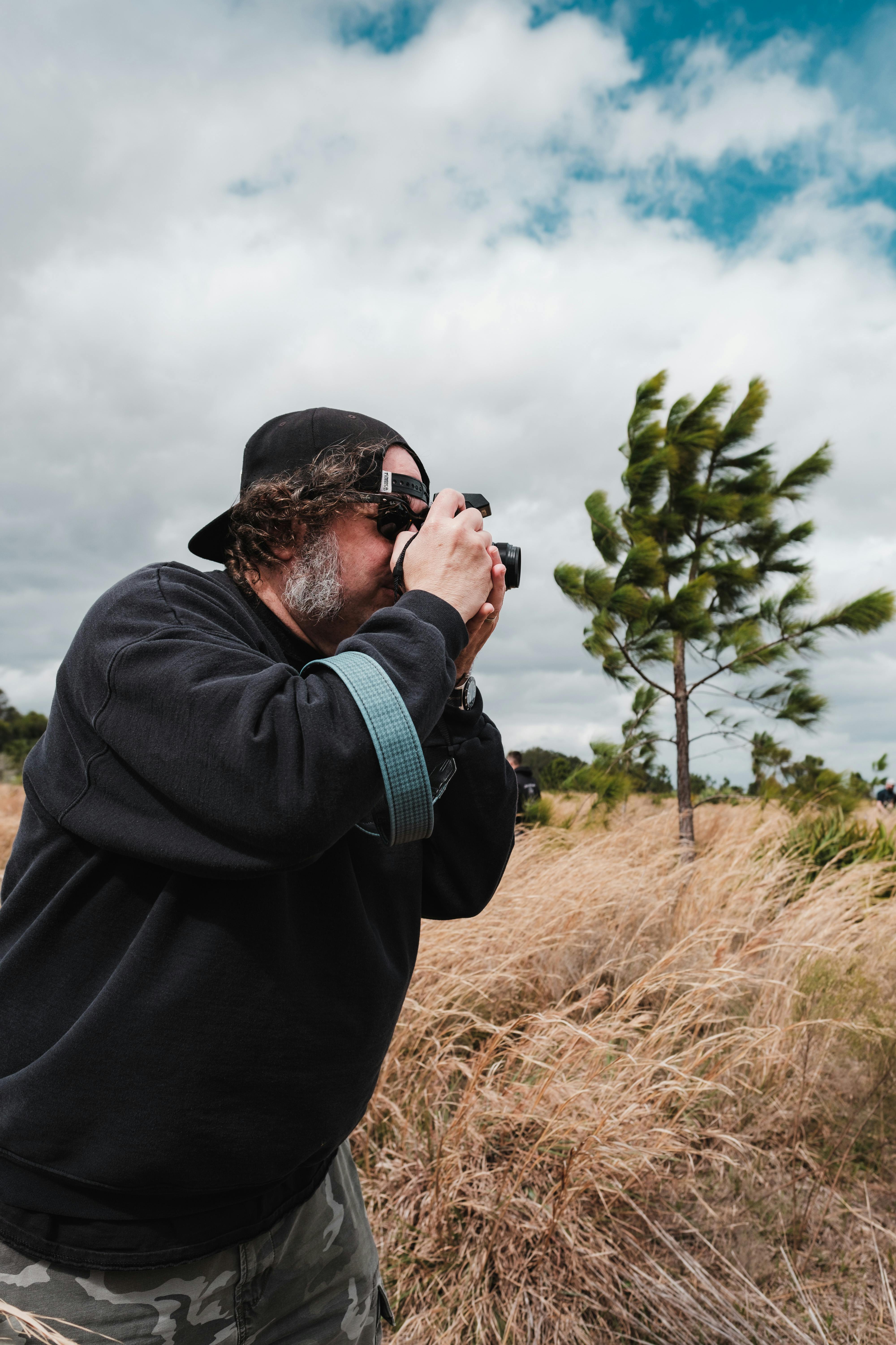 man taking pictures on field