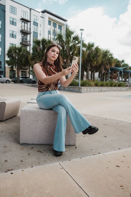 Woman Sitting and Taking Selfie