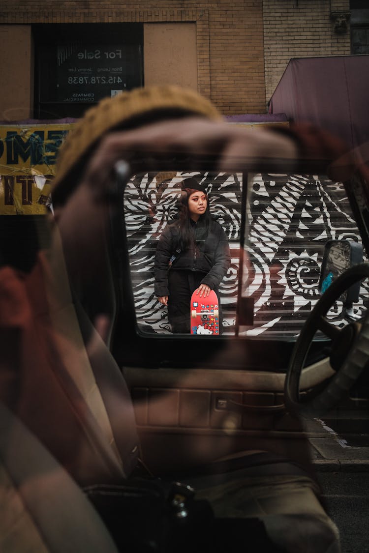 Girl With Skateboard Near Graffiti Wall In Car Window