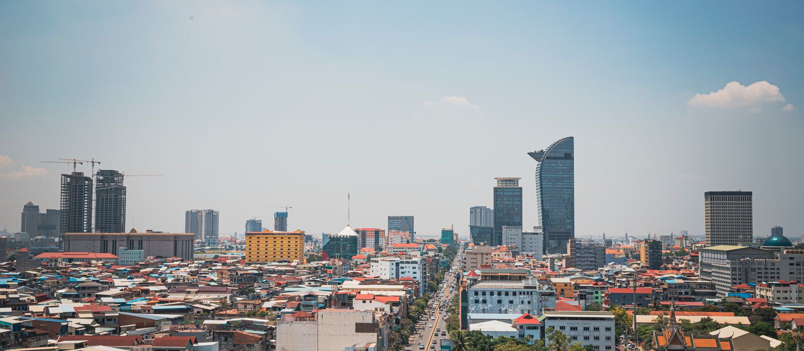 Discover the modern skyline and bustling streets of Phnom Penh from an aerial perspective. — flights from New York to Phnom Penh