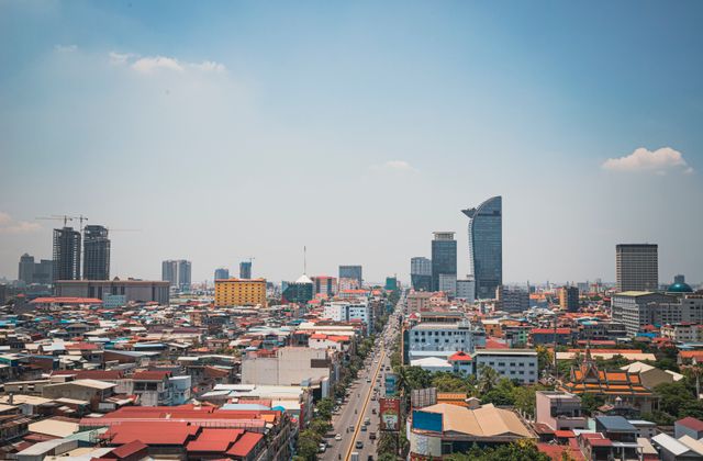 Discover the modern skyline and bustling streets of Phnom Penh from an aerial perspective. — arriving in Phnom Penh